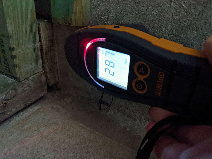 Moisture Meter Showing Hidden Mold Developing Moisture Within The Cinder Block